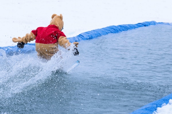 Person skiing over water in costume