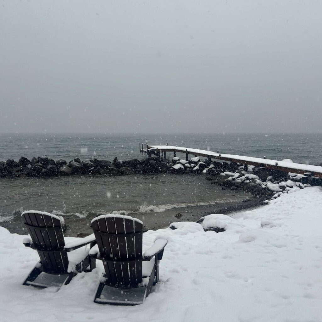 two chairs on a snowy day by the red wolf lakeside deck